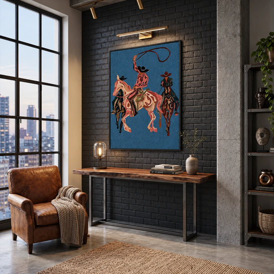 Blue Rodeo painting above a wooden console against a dark brick wall.