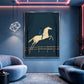 Twilight Leap painting between blue lounge chairs beneath soft accent lighting.