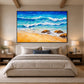 Turquoise Breakers in a slim black frame above a bed with neutral bedding and warm bedside lighting.