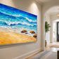 Turquoise Breakers in a silver frame on a pale entryway wall beside an arched doorway.