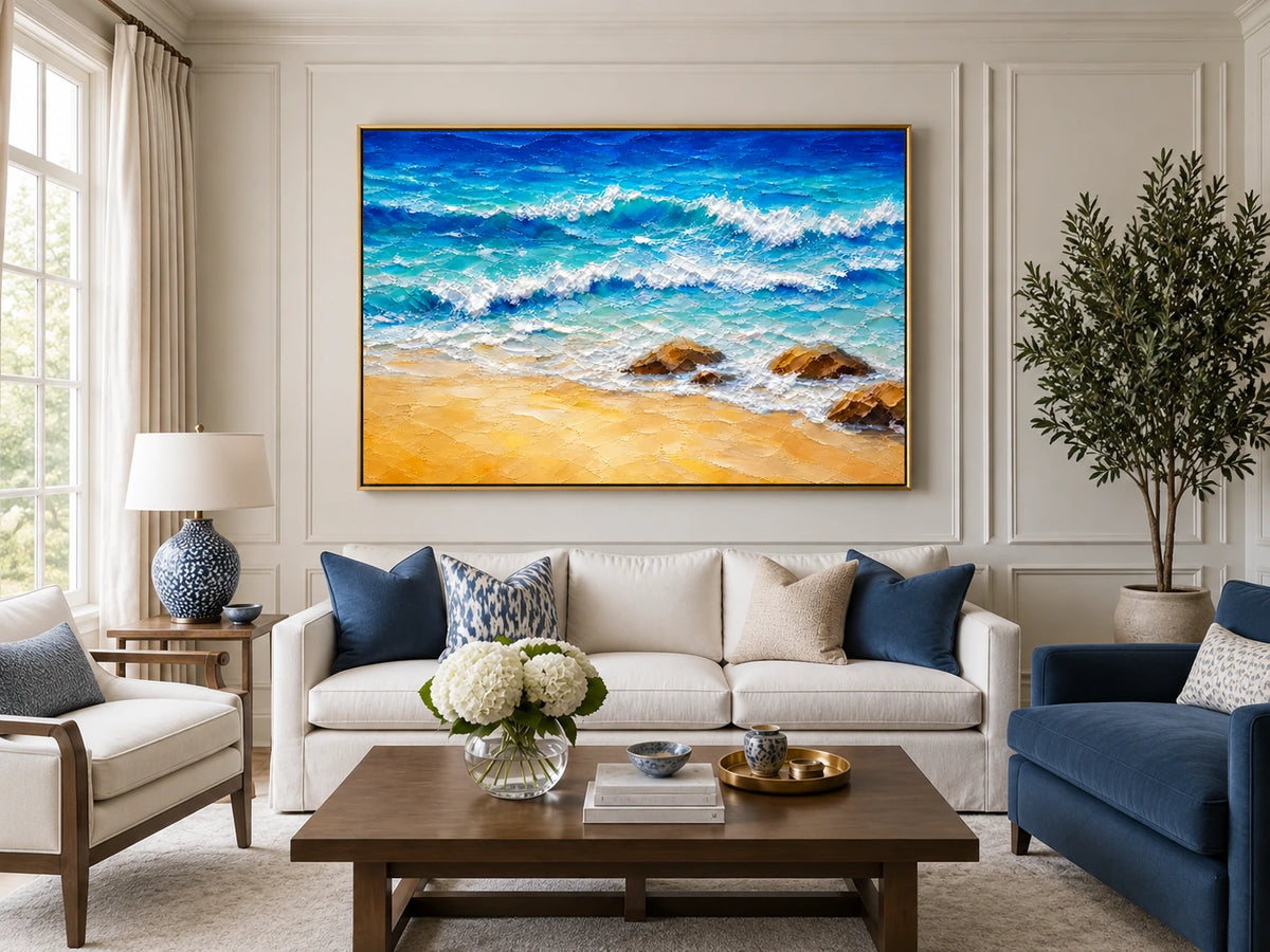 Turquoise Breakers in a gold frame above a pale sofa with blue armchairs in a bright living room.