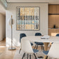 Pebble Grid artwork displayed beside a round dining table with white and blue chairs.