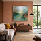 Mistbound Light artwork displayed above a sideboard beside pale seating and a terracotta wall.