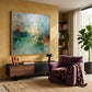 Mistbound Light artwork displayed above a low cabinet beside a plum armchair.
