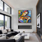 Chromatic Strings artwork displayed above a fireplace in a bright double-height living room.