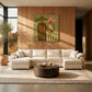 Olive Vows artwork displayed above pale seating and a round coffee table.