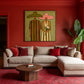 Olive Vows artwork displayed above a pale sofa against a red wall.