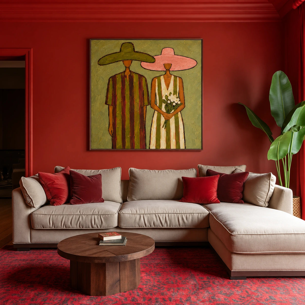 Olive Vows artwork displayed above a pale sofa against a red wall.