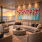 Blossom Confetti artwork displayed above seating overlooking the ocean at sunset.