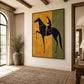 Ochre Rider artwork displayed on a pale wall in a sunlit entryway with tall windows.