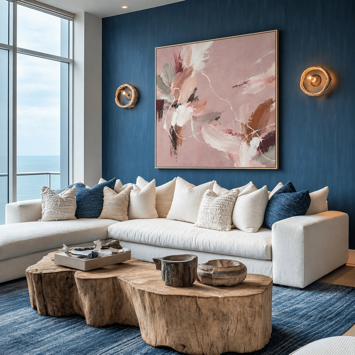 Blush Reverie artwork displayed above a cream sofa and round wooden coffee tables.