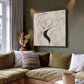 Poised Lines artwork displayed above a sofa with olive green cushions.