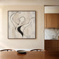 Poised Lines artwork displayed beside a dining table in a pale wood kitchen.