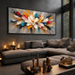 Prismatic Bloom artwork displayed above a charcoal sofa and dark coffee tables.