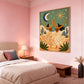 Celestial Dance artwork displayed above a bed against a soft pink wall.