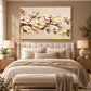 Ivory Branch artwork displayed above a bed with neutral layered bedding.