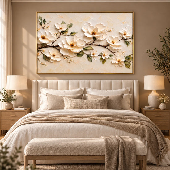 Ivory Branch artwork displayed above a bed with neutral layered bedding.