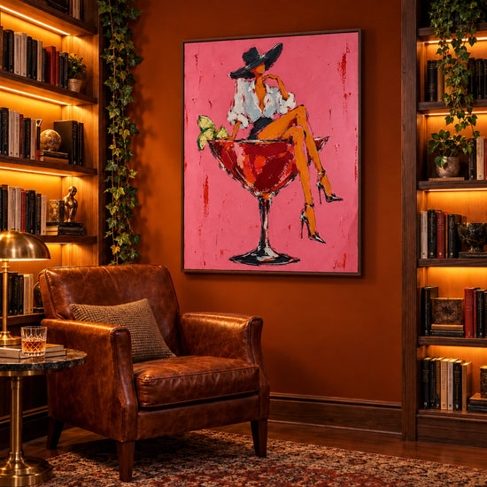 Cocktail Muse artwork displayed beside bookshelves and a leather lounge chair.