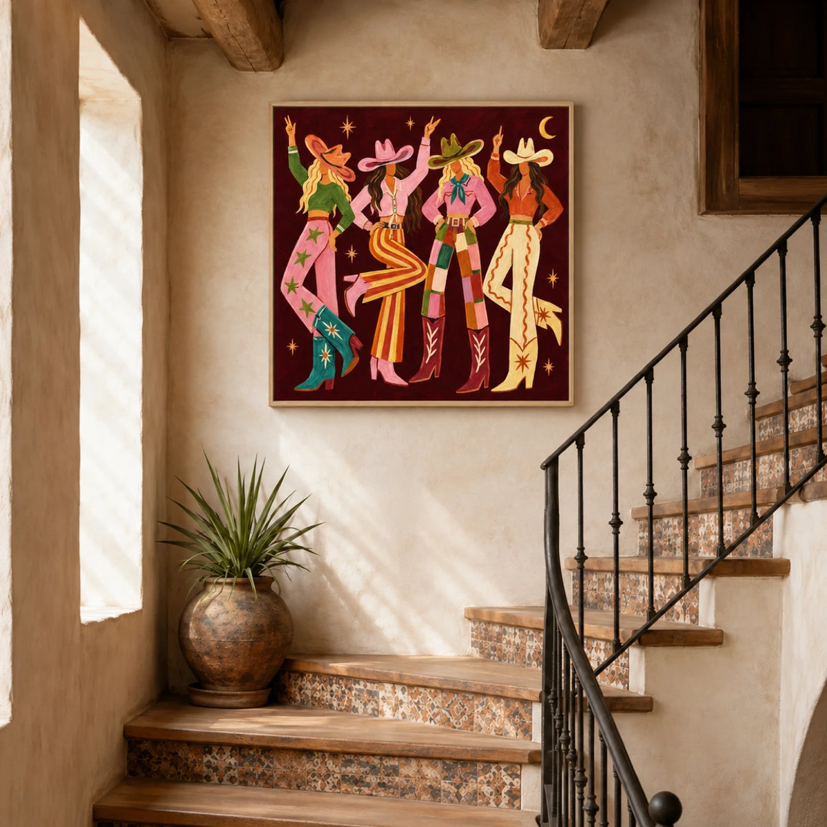 Cowgirl Revelry artwork displayed above a stone console beside a staircase and tall window.
