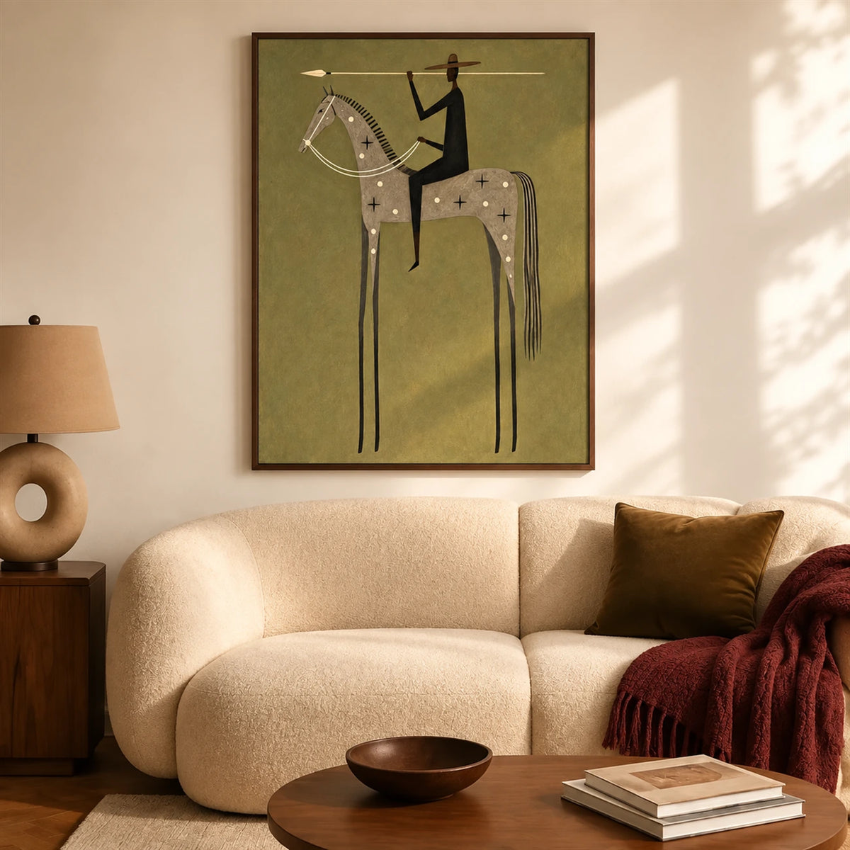 Starbound Rider artwork displayed above a cream sofa beside a sunlit window.