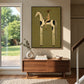 Dappled Rider artwork displayed above a wooden console beside a garden-facing doorway.
