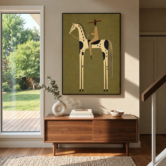 Dappled Rider artwork displayed above a wooden console beside a garden-facing doorway.