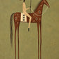 Chestnut Standard full artwork. A rider in pale clothing holds a long spear above a chestnut horse decorated with cream geometric marks.