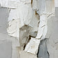 Ivory Rift full artwork. Layered ivory and pale gray form a rugged vertical landscape of ridges, fractures, and quiet shadows.