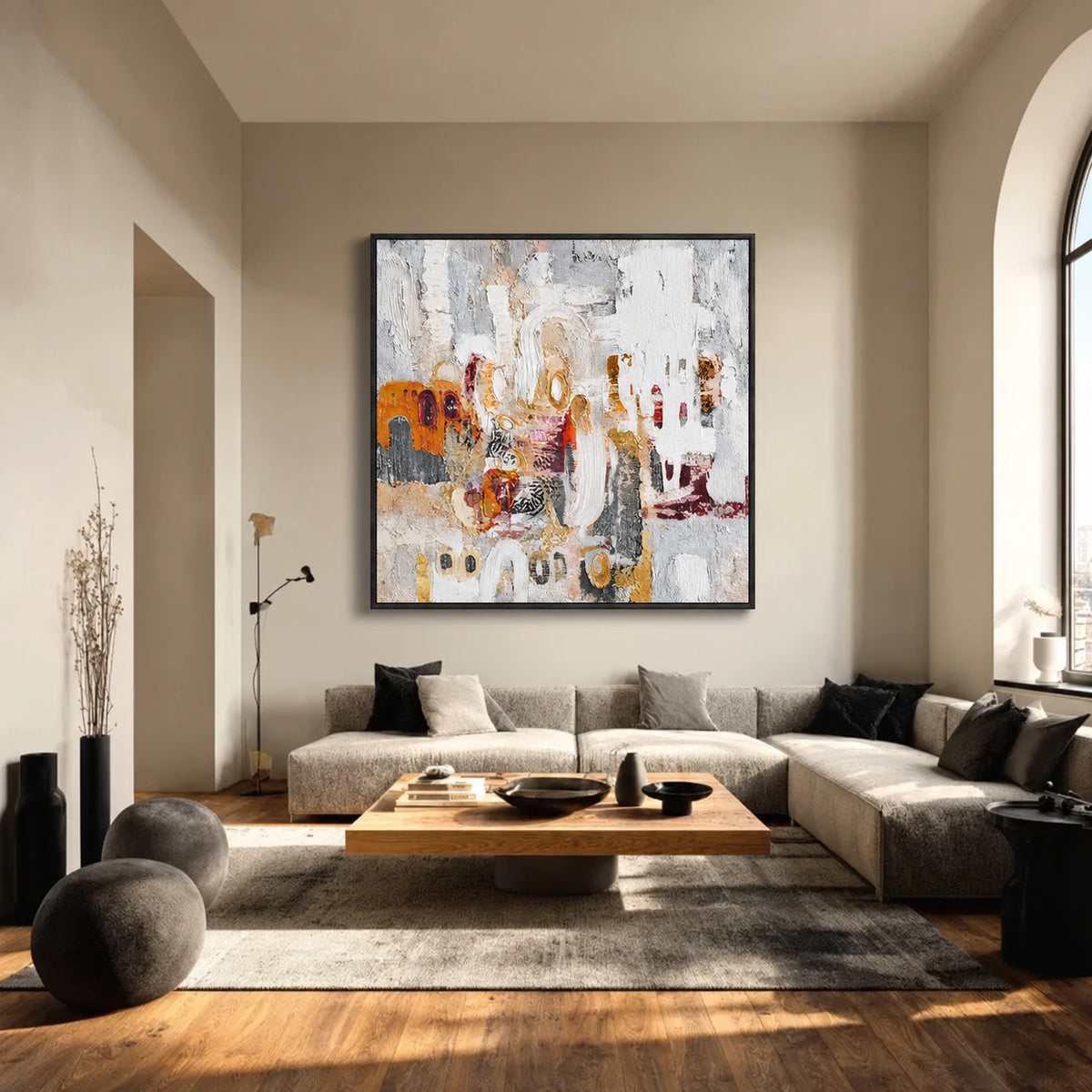 Ochre Palimpsest artwork displayed above a sectional beside arched windows.