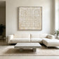 Ivory Rings artwork displayed above a white sectional sofa.
