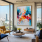 Chromatic Flourish artwork displayed beside city-view windows and a mustard chair.