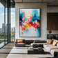 Chromatic Flourish artwork displayed above a sectional in a glass-walled lounge.