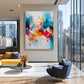 Chromatic Flourish artwork displayed beside a mustard sofa overlooking the city.