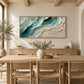Jade Shoreline artwork displayed above a dining table and woven chairs.