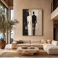 Divided Silhouette artwork displayed above a cream sofa beside tall windows.