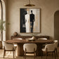 Divided Silhouette artwork displayed above a dining table and upholstered chairs.