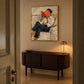 Vermilion Pages artwork displayed above a dark wooden sideboard.