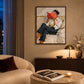 Vermilion Pages artwork displayed above a sideboard beside a cream armchair.
