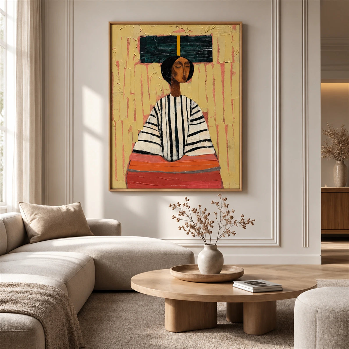 Ochre Poise artwork displayed above a cream sectional in a bright lounge.