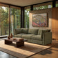 Pastel Highlands artwork displayed above a green sofa beside garden windows.
