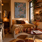 Trailing Orchids artwork displayed above a daybed beside dining seating.