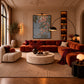 Trailing Orchids artwork displayed above red seating in an ornate living room.