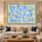 Periwinkle Garden artwork displayed above a cream sofa with blue cushions.