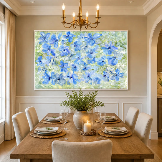 Periwinkle Garden artwork displayed above a dining table beneath a chandelier.