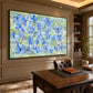 Periwinkle Garden artwork displayed above a wooden desk in a study.