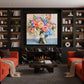 Garden Keepsake artwork displayed above a fireplace between bookshelves.
