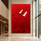 Crimson Flight Wall Art in a slim gold frame displayed beside floor-to-ceiling windows in a sunlit interior.