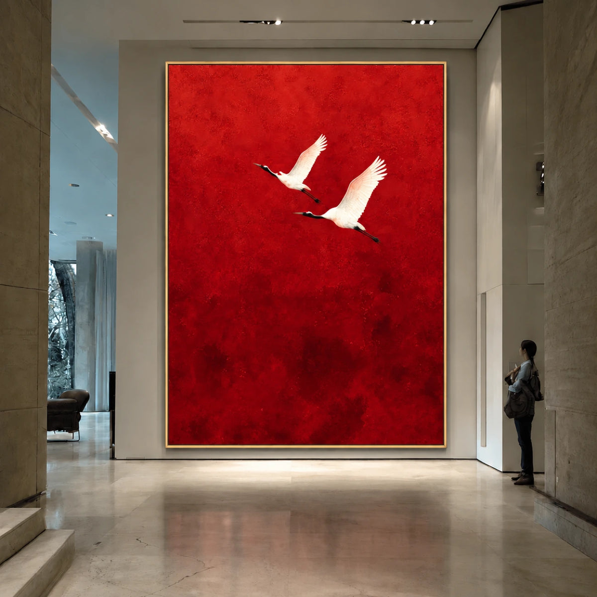 Crimson Flight Wall Art in a slim gold frame on a tall gallery wall, with a visitor nearby for scale.