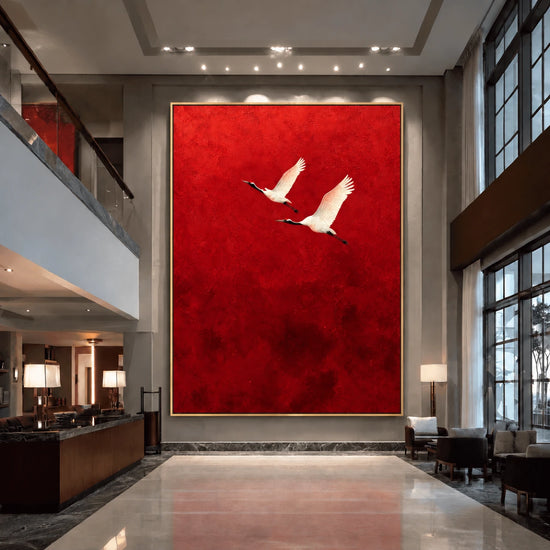 Crimson Flight Wall Art in a slim gold frame displayed above a reception area in a double-height contemporary lobby.