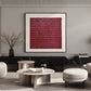 Burgundy Rhythm artwork displayed above seating and low tables against a paneled wall.